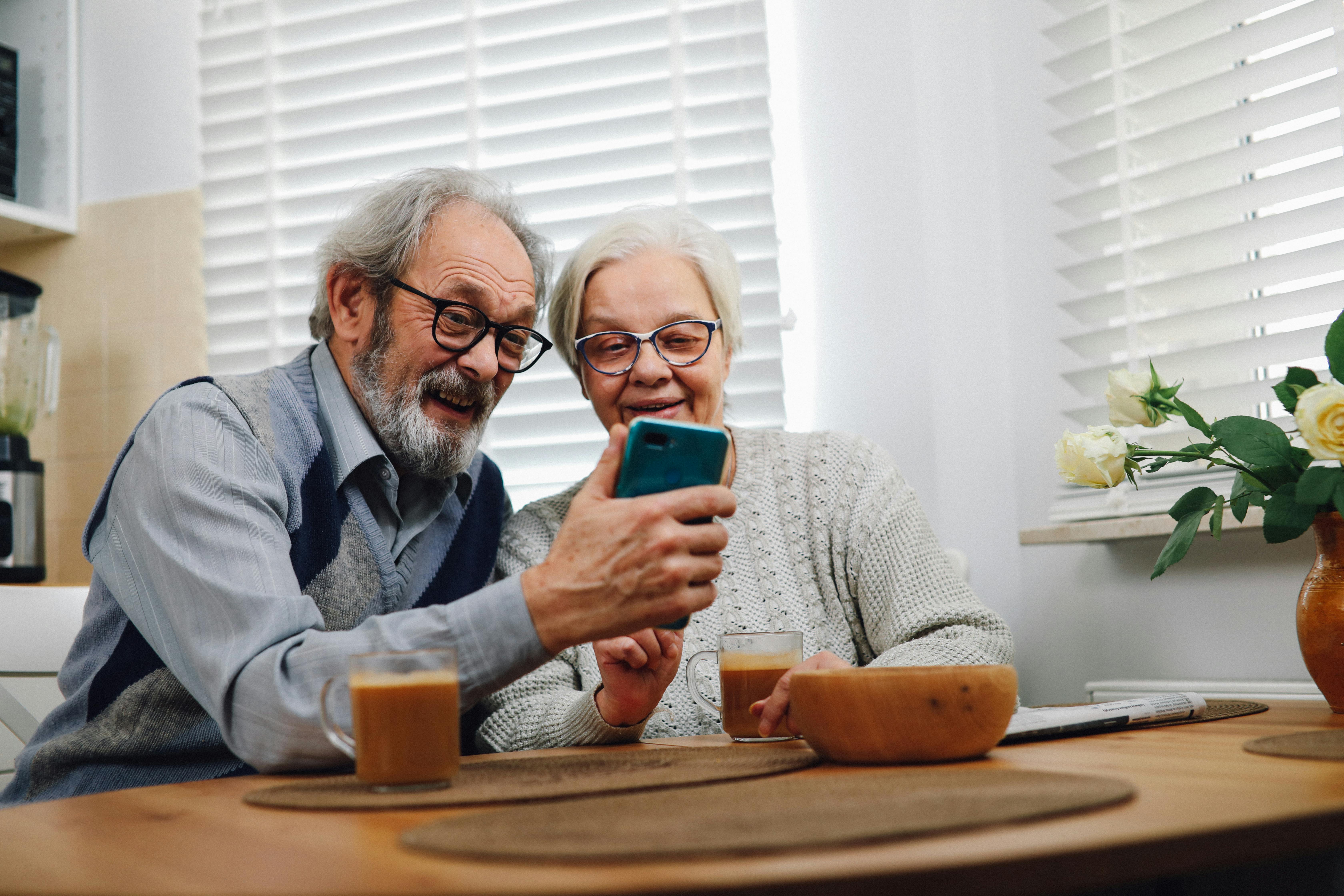 Happy couple reviewing Medicare options with an agent